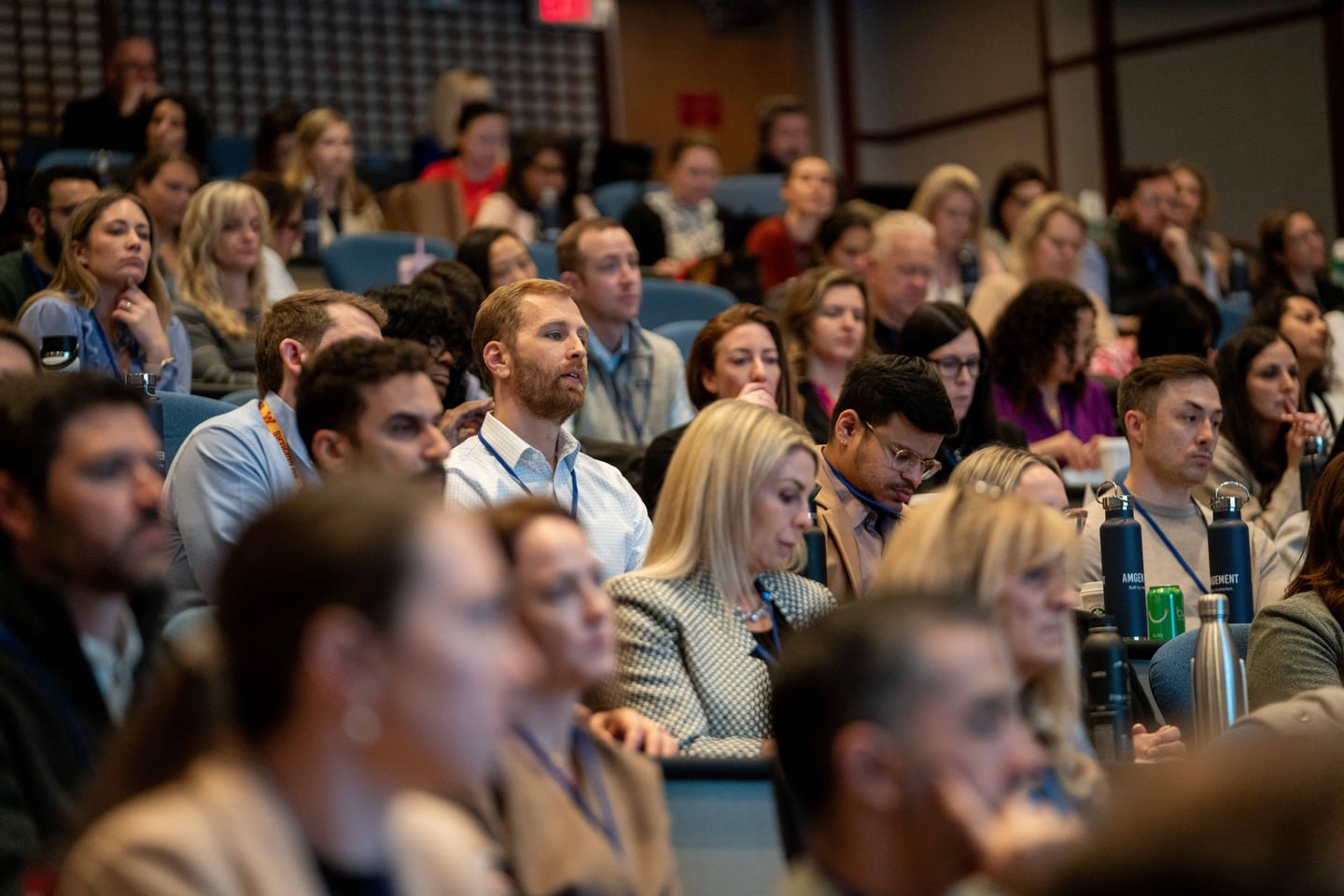 Attendees seated in the audience at an Amgen corporate conference