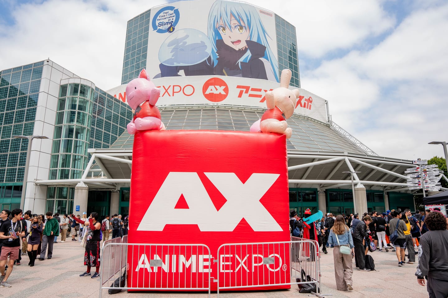 A giant inflatable AX Anime Expo cube with anime character balloons at the Convention Center entrance
