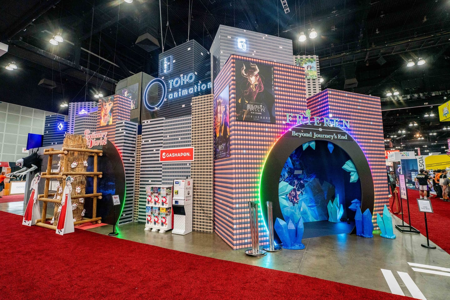 The Toho Animation exhibitor booth with an illuminated blue archway and a Frieren display at Anime Expo