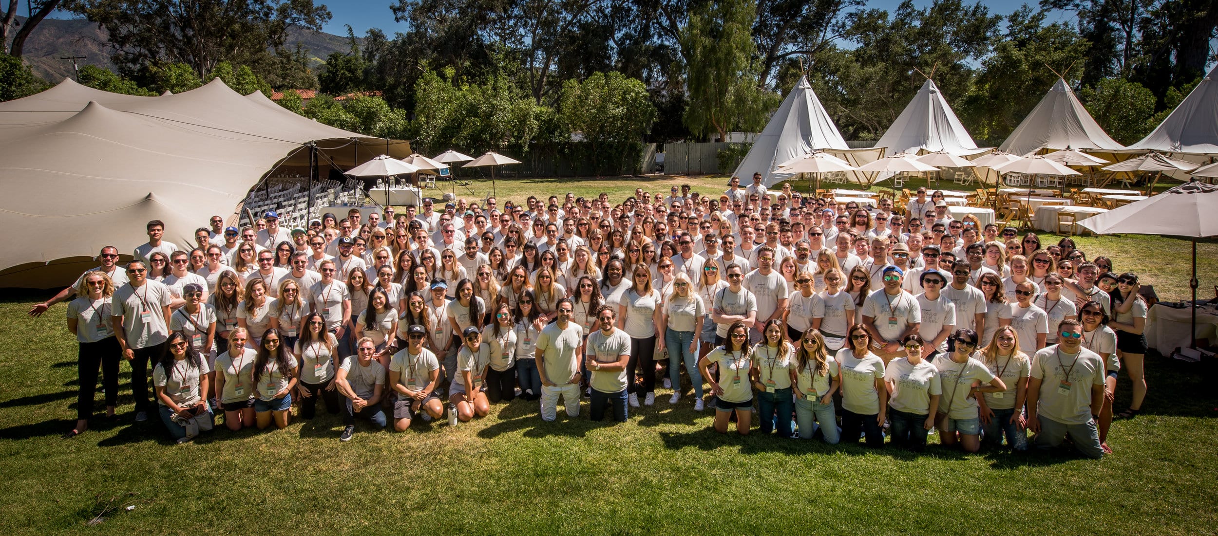 The GumGum team gathered for a group photo on a lawn at a company offsite