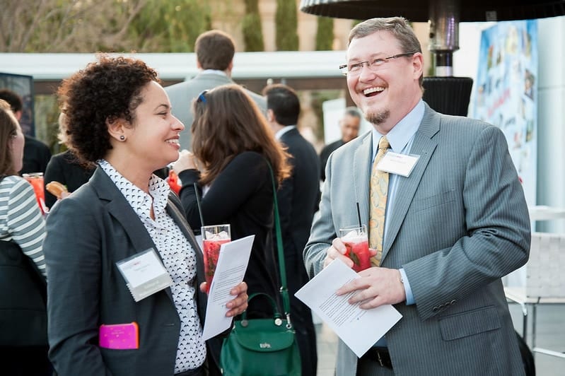 Two guests laughing during a networking break at a corporate conference