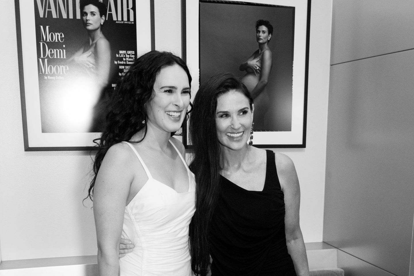 Demi Moore photographed at a Vanity Fair event, beside her magazine cover