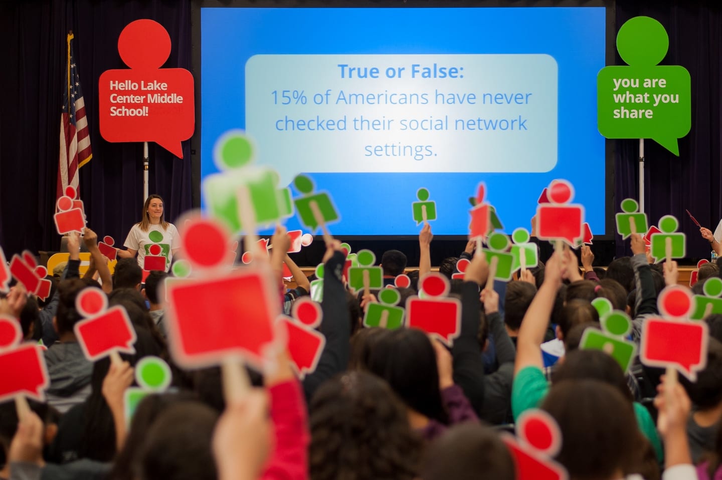 An audience raising red and green cards during a Google internet-safety presentation