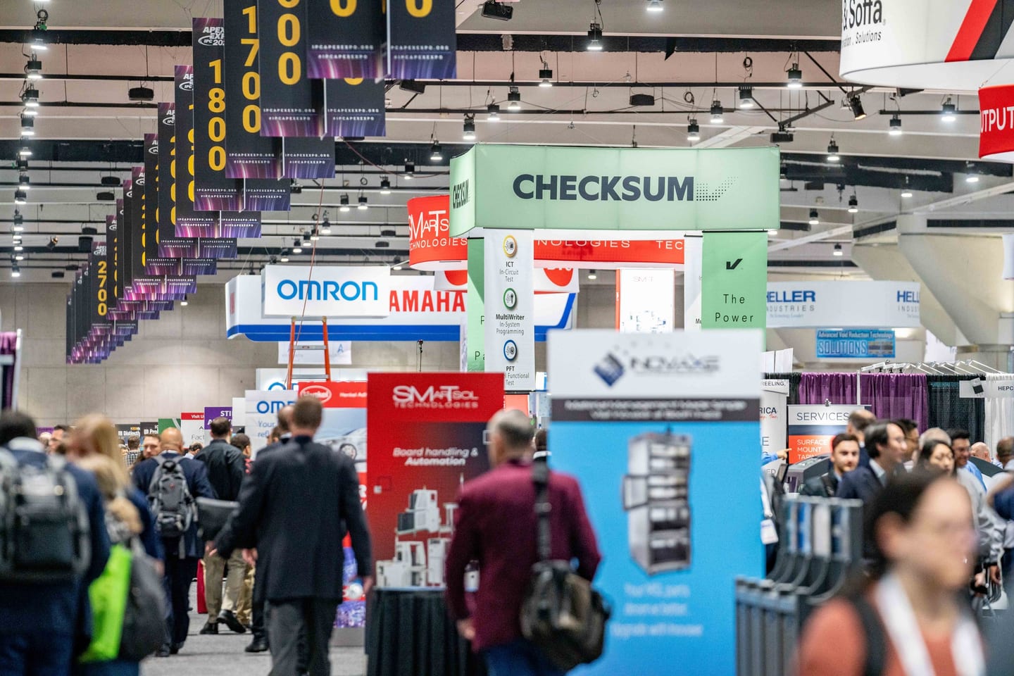 Attendees among vendor booths on the exhibition floor at the IPC APEX EXPO trade show