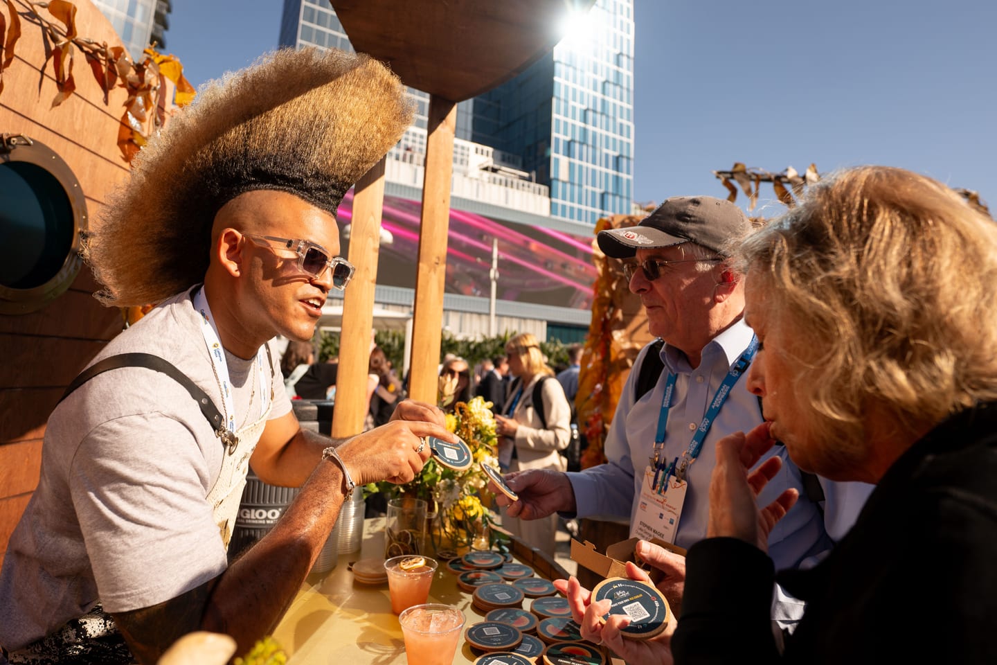 A vendor serving guests at an outdoor activation in IPW’s California Plaza beside the Los Angeles Convention Center