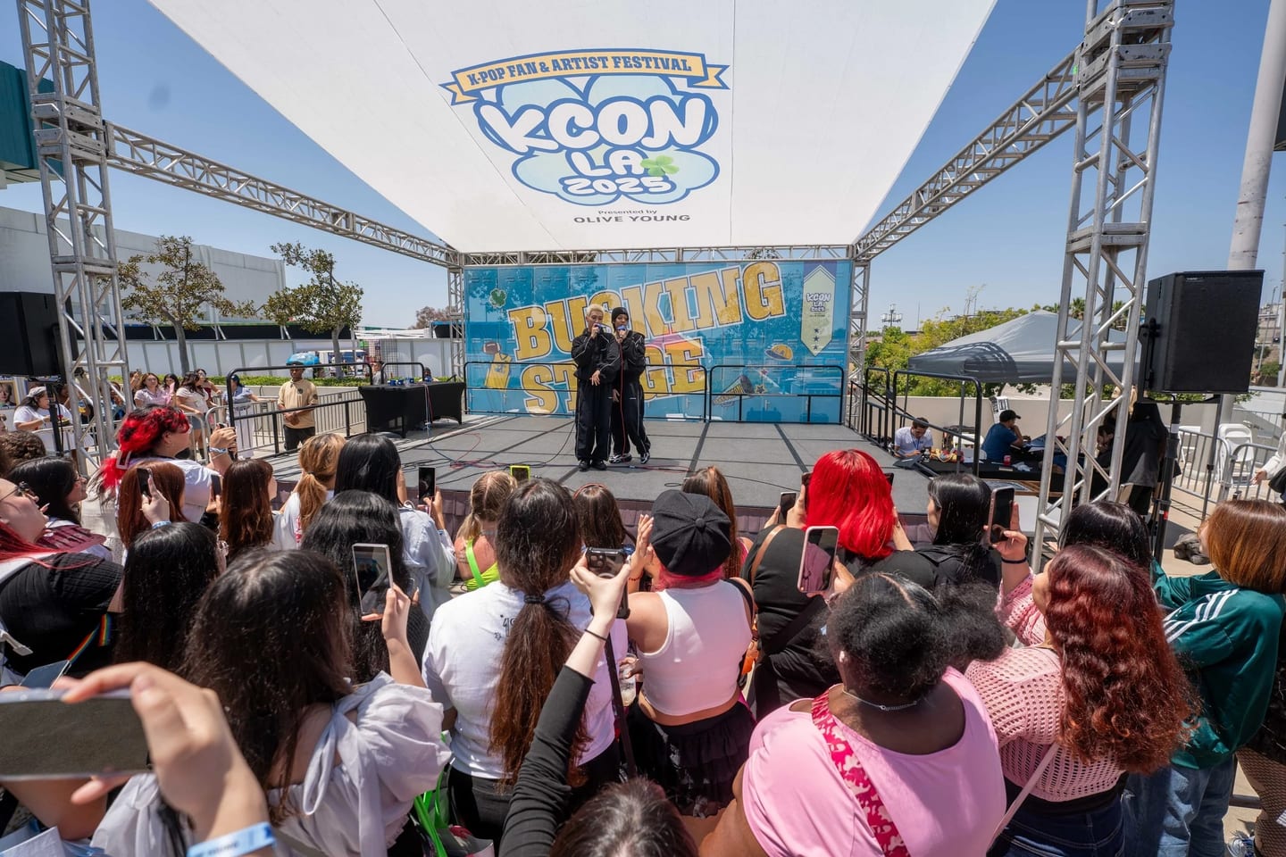 A crowd filming two performers on the outdoor Breaking Stage at KCON LA 2025