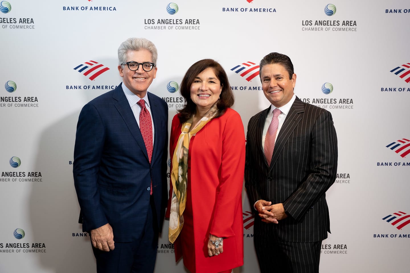 Three guests posing on the Los Angeles Area Chamber of Commerce and Bank of America step-and-repeat at a corporate event in Los Angeles