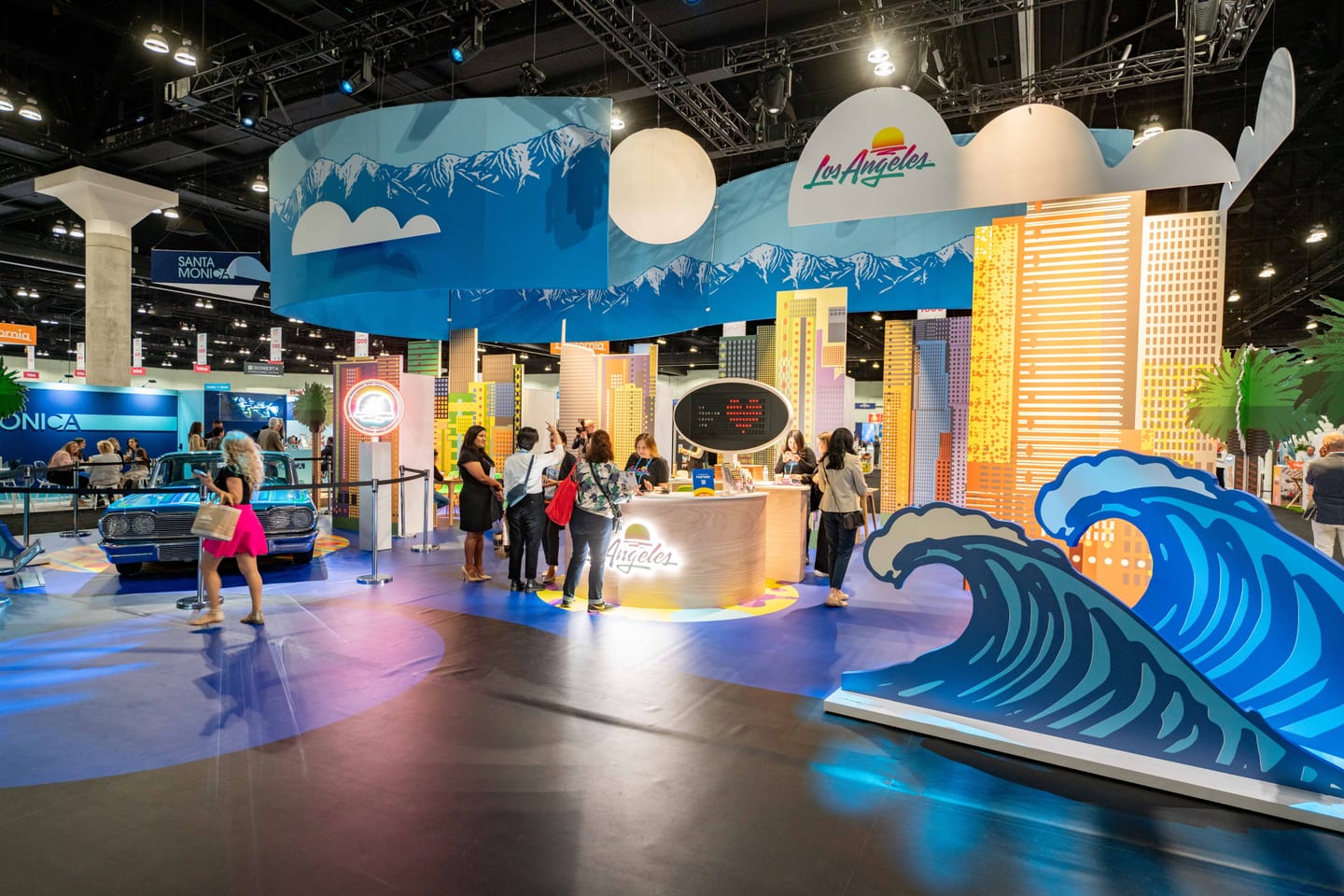 The Los Angeles tourism booth with a large wave installation on the IPW trade show floor
