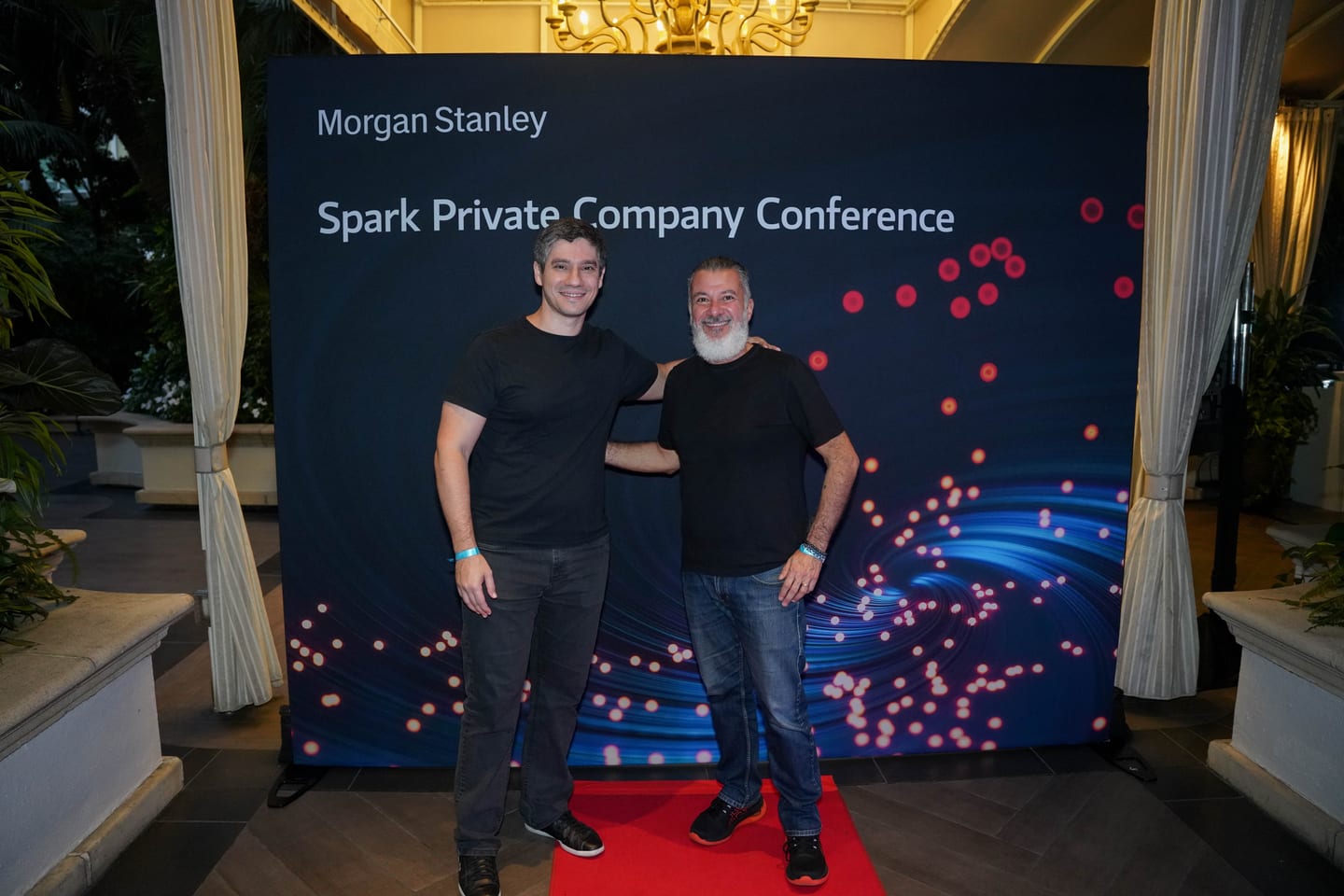 Two guests on the step-and-repeat at the Morgan Stanley Spark Private Company Conference in Los Angeles