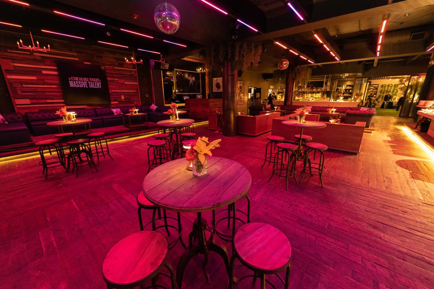 A softly lit modern lounge set with red accent lighting for a premiere after-party in Downtown Los Angeles