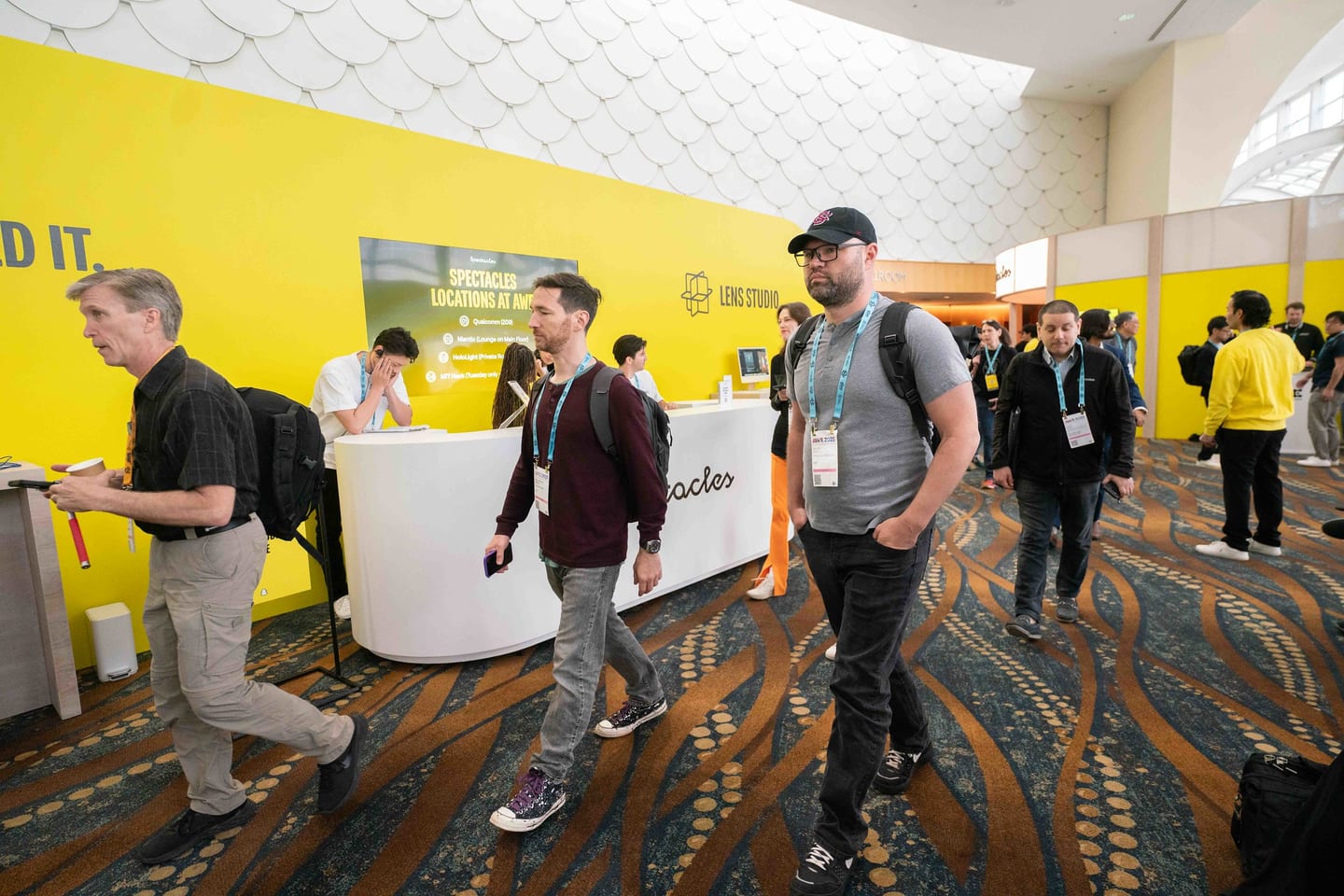 The bright yellow Snapchat Spectacles and Lens Studio booth on the Augmented World Expo show floor in Long Beach
