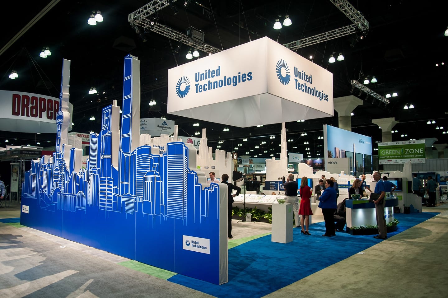 Large branded United Technologies trade-show booth with a blue skyline design on the exhibition floor