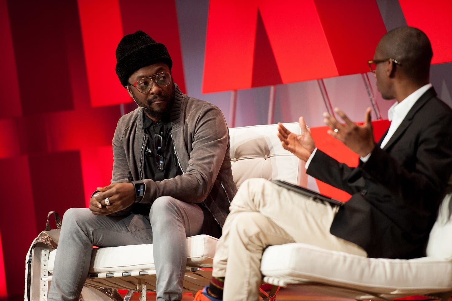 will.i.am seated in a fireside conversation on stage at a Havas Media conference